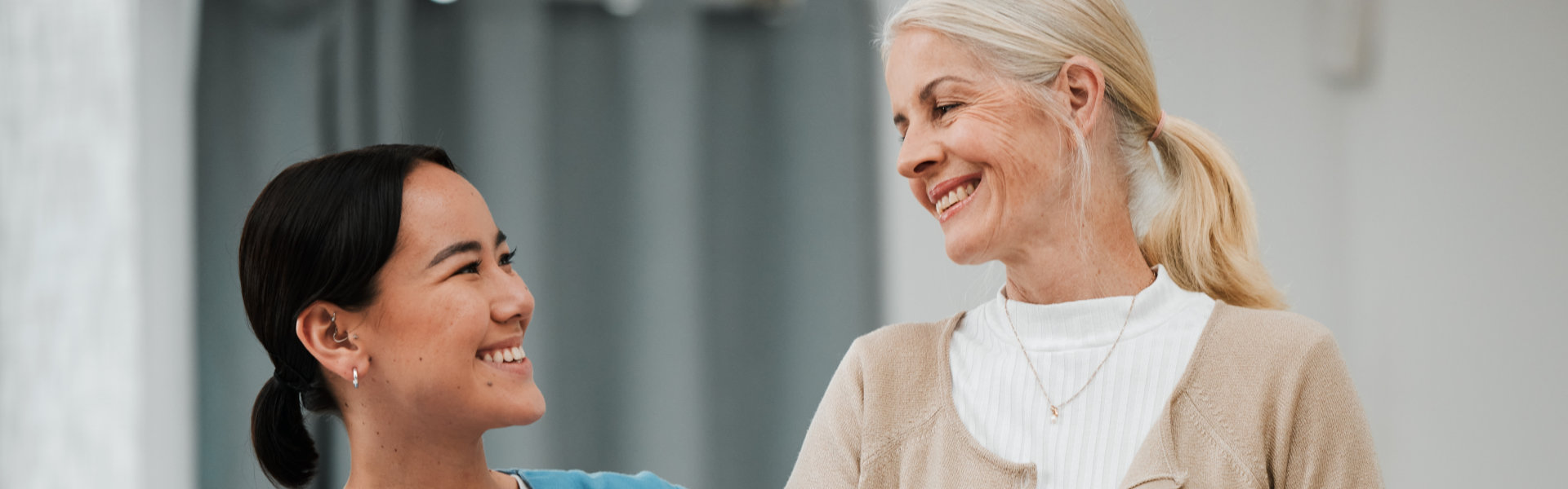 caregiver smiling to senior woman