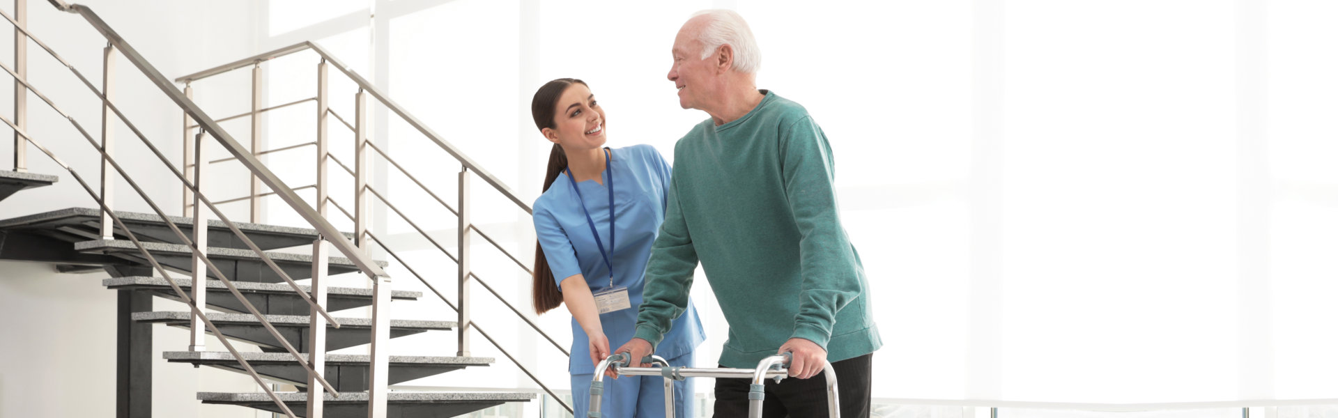 caregiver assisting man to walk